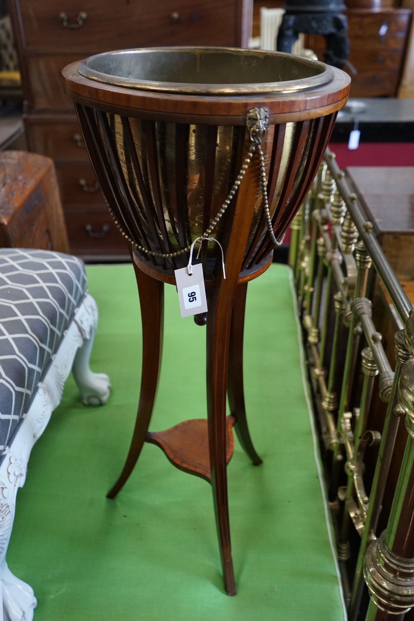 An Edwardian satinwood banded mahogany jardiniere with brass liner, diameter 35cm, height 85cm.